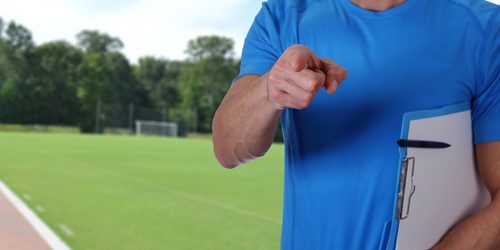 Football, soccer trainer with workout plan close up on football